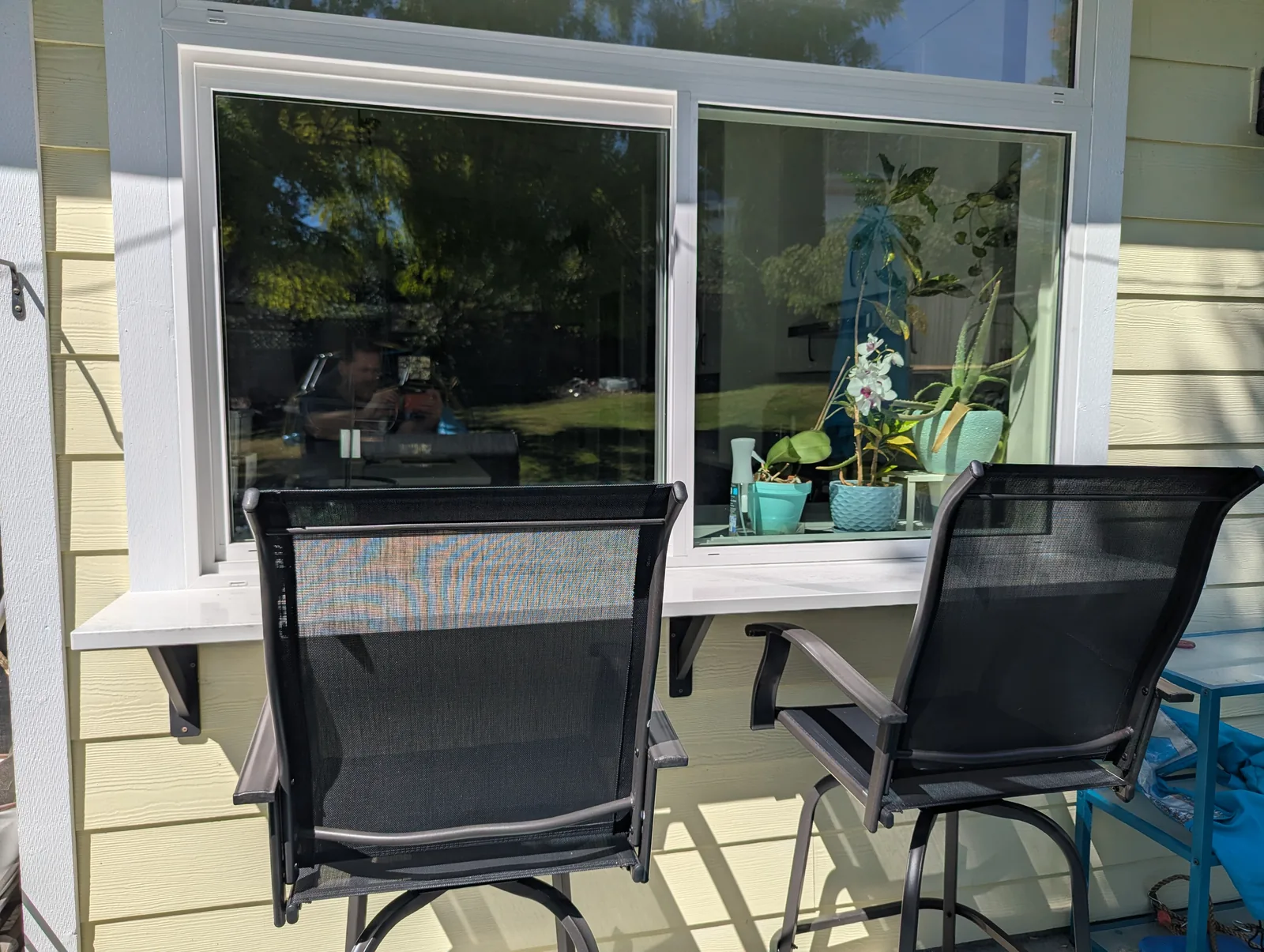 Outdoor patio bar ledge seating connected to kitchen window